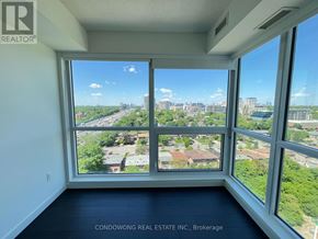 Toronto (Bayview Village) condo for rent - A room with a large window overlooking a cityscape.