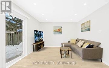 Toronto (L'amoreaux) townhouse for rent - A living room with a couch, a coffee table, and a painting on the wall.