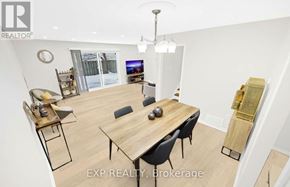 Toronto (L'amoreaux) townhouse for rent - A dining room with a wooden table and chairs.