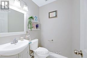 Toronto (L'amoreaux) townhouse for rent - A white bathroom with a toilet, sink, and a mirror.