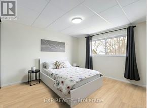 Toronto (L'amoreaux) townhouse for rent - A bedroom with a bed, nightstand, and window.