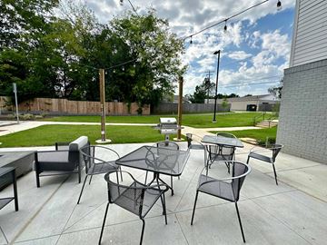 Huntsville apartment for rent - A patio with black metal furniture and a table.