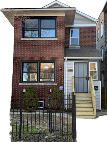 Chicago apartment for rent - A red brick house with a grey door and a small window.