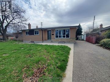 Brampton (Avondale) apartment for rent - A house with a brown roof and a green lawn in front.