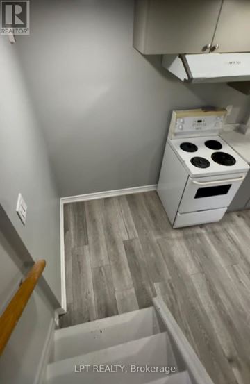 Brampton (Northgate) apartment for rent - A small kitchen with a stove and a wooden floor.