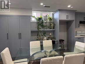 Clarington (Bowmanville) apartment for rent - A modern kitchen with a glass table and white chairs.