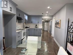 Clarington (Bowmanville) apartment for rent - A modern kitchen with a glass table in the middle.