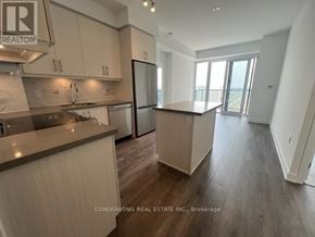 Richmond Hill (Langstaff) condo for rent - A kitchen with a refrigerator, sink, and cabinets.