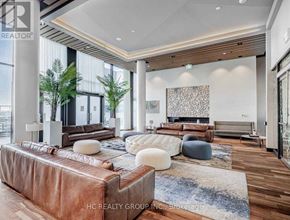 Markham (Unionville) condo for rent - A modern living room with a brown leather sofa and a wooden floor.