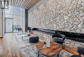 Markham (Unionville) condo for rent - A modern living room with a stone wall and wooden flooring.