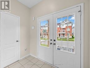 Ajax (Northeast Ajax) apartment for rent - A white door with a window showing a residential building.
