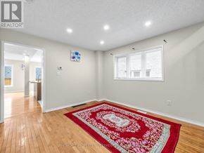 Ajax (Northeast Ajax) apartment for rent - A room with a red rug on the floor and a window with blinds.