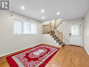 Ajax (Northeast Ajax) apartment for rent - A room with a red rug and wooden stairs.
