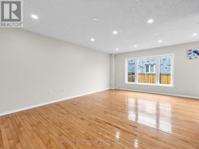 Ajax (Northeast Ajax) apartment for rent - A spacious room with wooden flooring and a large window.