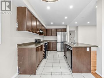 Ajax (Northeast Ajax) apartment for rent - A kitchen with brown cabinets and a white floor.