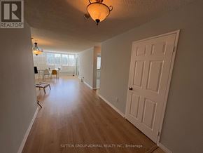 Vaughan (Crestwood-Springfarm-Yorkhill) condo for rent - A hallway with a white door and a light fixture on the ceiling.