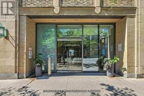 Toronto (Bay Street Corridor) condo for rent - The entrance to a building with glass doors and a sign that reads "332".