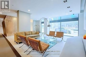 Toronto (Bay Street Corridor) condo for rent - A modern living room with a glass table and a sofa.