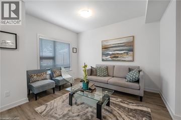 Kitchener townhouse for rent - A living room with a grey couch and a glass coffee table.