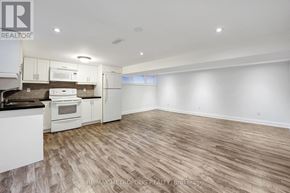 Newmarket (Bristol-London) apartment for rent - A spacious kitchen with white appliances and wooden flooring.