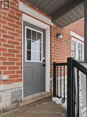 Barrie (Georgian Drive) townhouse for rent - A house with a grey door and a sign that says "For Sale".