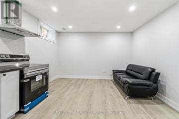 Mississauga (Streetsville) apartment for rent - A modern kitchen with a black leather sofa in the living room.