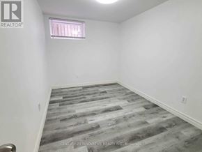 Oshawa (Centennial) apartment for rent - A room with a grey wooden floor and a window with blinds.