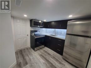 Oshawa (Centennial) apartment for rent - A kitchen with black cabinets and stainless steel appliances.