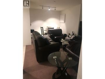 North Vancouver apartment for rent - A living room with a black couch and a glass table.