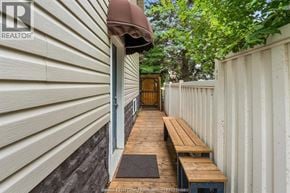 Windsor apartment for rent - A wooden bench is placed on a wooden platform outside a house.