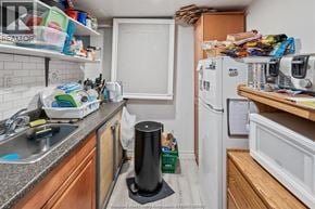 Windsor apartment for rent - A kitchen with a white fridge, wooden countertops, and a black trash can.