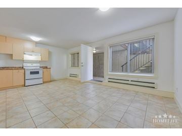 Surrey apartment for rent - A spacious kitchen with beige cabinets and a tiled floor.