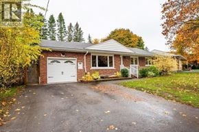 Kitchener apartment for rent - A house with a garage and a driveway in front of it.