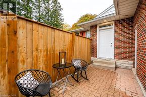 Kitchener apartment for rent - A patio with a chair and a table with a candle on it.