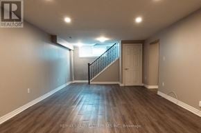 Hamilton (Hampton Heights) apartment for rent - A spacious room with wooden flooring and a staircase leading to another room.