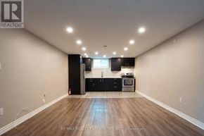 Hamilton (Hampton Heights) apartment for rent - A spacious room with a kitchenette and wooden flooring.