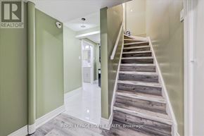 Toronto (Malvern) apartment for rent - A staircase with wooden steps and a white railing.