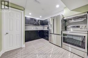 Toronto (Malvern) apartment for rent - A kitchen with a white door and stainless steel appliances.