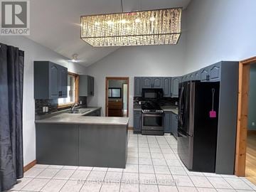 Melancthon apartment for rent - A kitchen with a black refrigerator and a chandelier hanging from the ceiling.