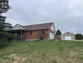 Melancthon apartment for rent - A house with a brown brick exterior and a white garage door.