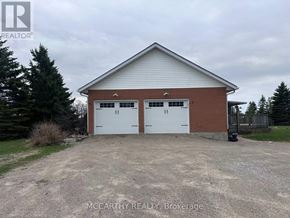 Melancthon apartment for rent - A two-car garage with a brick exterior and a white roof.