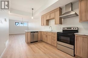 North Stormont multi-family for rent - A kitchen with wooden cabinets and stainless steel appliances.