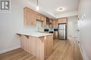 North Stormont multi-family for rent - A kitchen with wooden cabinets and a white countertop.