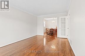 Markham (Village Green-South Unionville) apartment for rent - A room with wooden floors and white walls, with a dining table and chairs in the background.