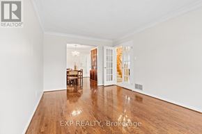 Markham (Village Green-South Unionville) apartment for rent - A room with wooden floors and white walls, with a dining table and chairs in the background.