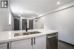 Brantford apartment for rent - A modern kitchen with white countertops and stainless steel appliances.