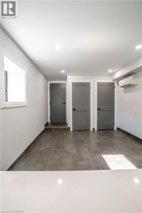 Brantford apartment for rent - A hallway with two doors and a window.