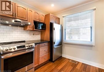 Hamilton townhouse for rent - A kitchen with wooden cabinets and stainless steel appliances.