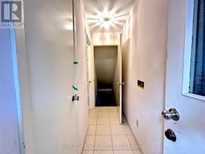 Toronto (L'amoreaux) apartment for rent - A hallway with a light on the ceiling and a door at the end.