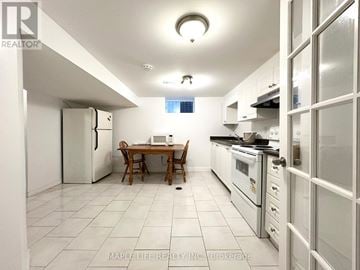 Toronto (L'amoreaux) apartment for rent - A kitchen with a table and chairs in the middle of it.